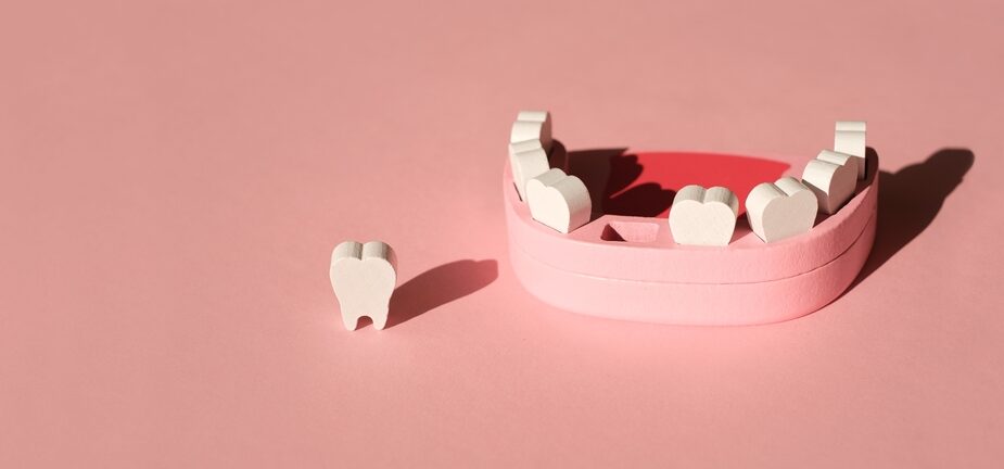 ilustração de uma arcada dentária faltando um dente, que está destacado ao lado